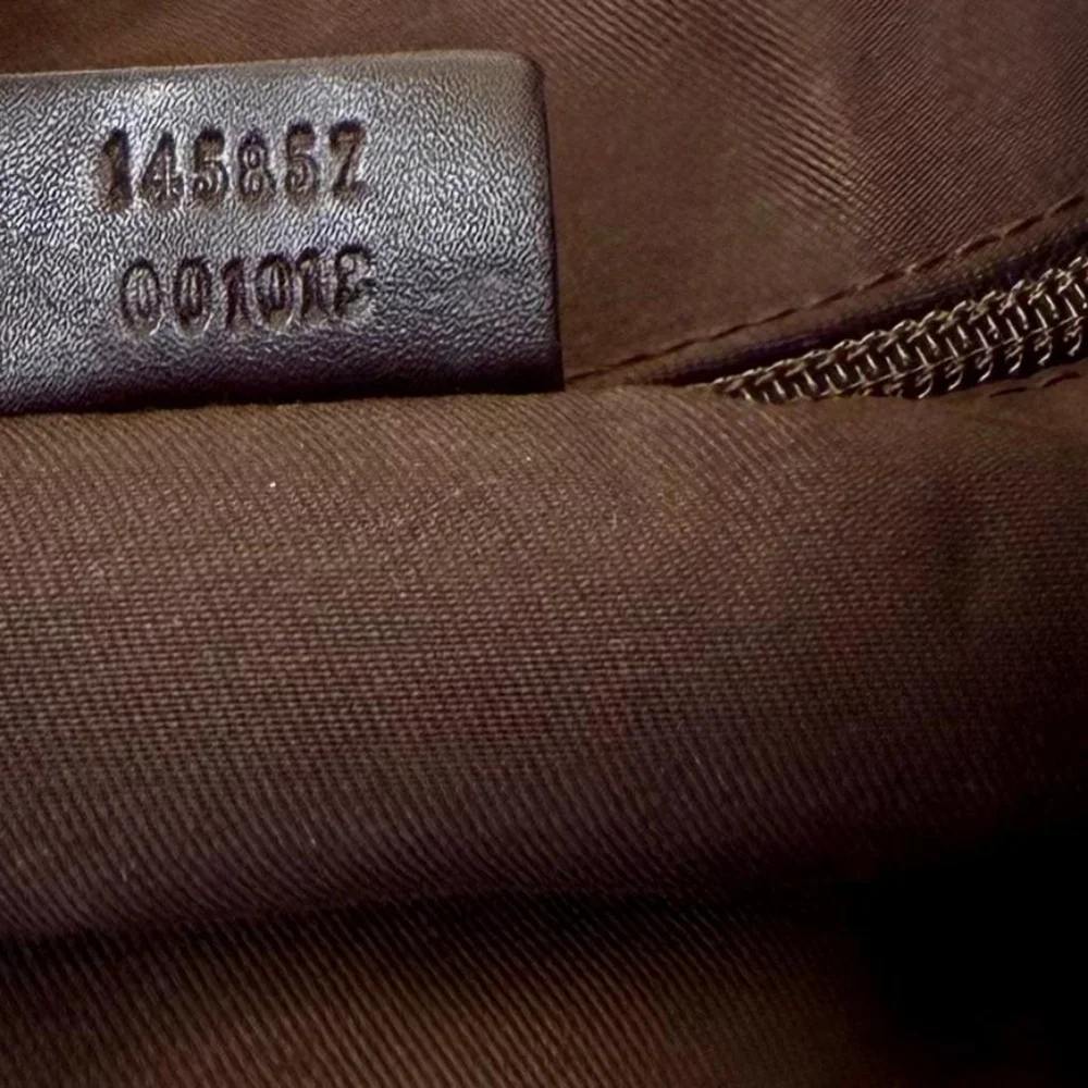 Gucci GG Monogram perforated leather messenger bag